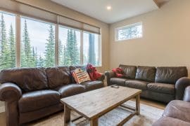 Living room with 3 leather couches, large bright windows with mountain views in this brand new suite on the Knoll. Large heated ski/boot room, private hot tub, laundry, fireplace, and fully stocked kitchen. Easy ski in and out access to trails and lifts.