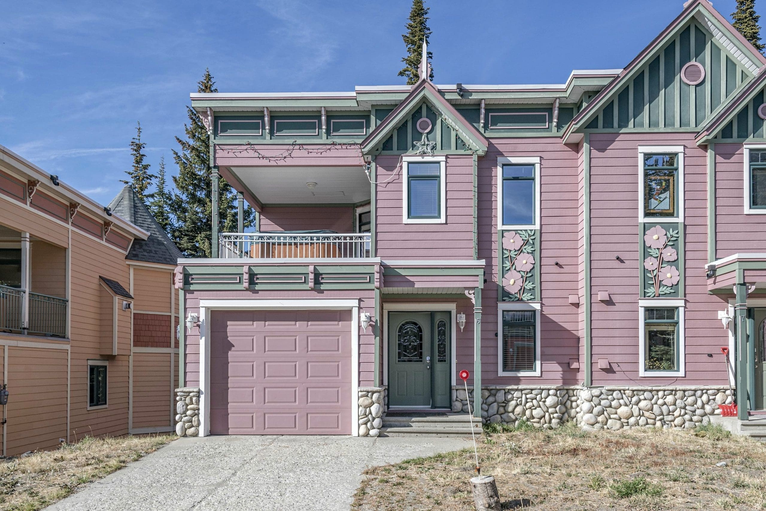 Mountain Rose exterior. Pink 3 level townhouse with space for everyone to spread out and a den for the kids. Enjoy the private hot tub, laundry, BBQ, and garage for storage/parking.