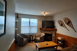 Living Room of Mountain Legacy condo at Creekside. Ground floor entrance with patio overlooking Silver Queen. Ski in and out right from your door to the slopes. Newly upgraded with full kitchen, BBQ, gas fireplace and free parking. It's pet-friendly too!