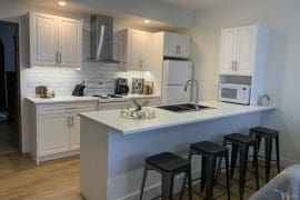 Suite Kitchen and breakfast bar. Modern appliances, open concept, bright private suite. Private hot tub, laundry, and everything you need for a couples or small family getaway.