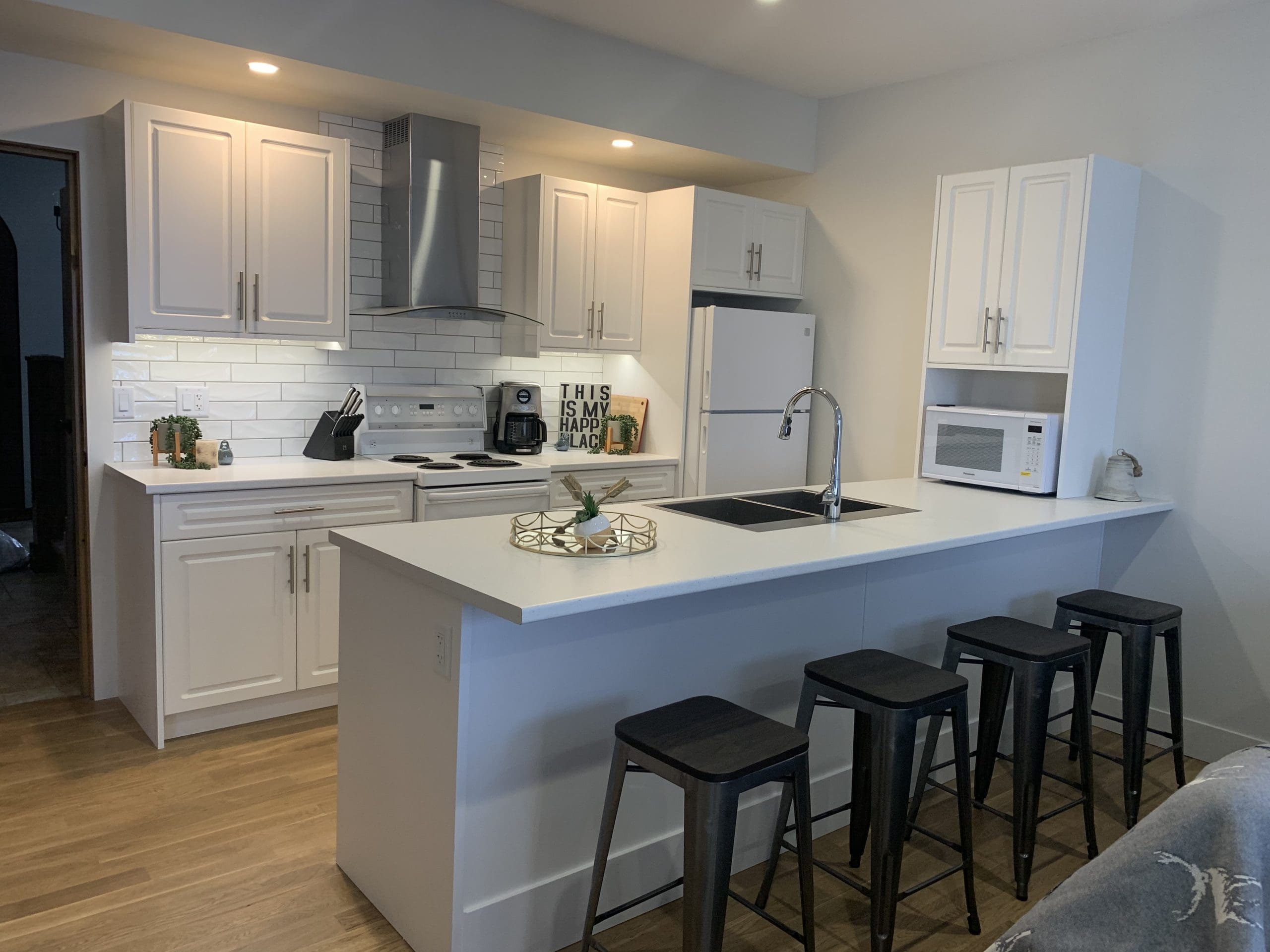 Suite Kitchen and breakfast bar. Modern appliances, open concept, bright private suite. Private hot tub, laundry, and everything you need for a couples or small family getaway.