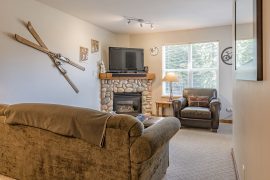 Bright, open living room of ground floor condo at Creekside. Pet friendly, gas fireplace, easy access through the ski locker to the hill to start your day. Free parking too.