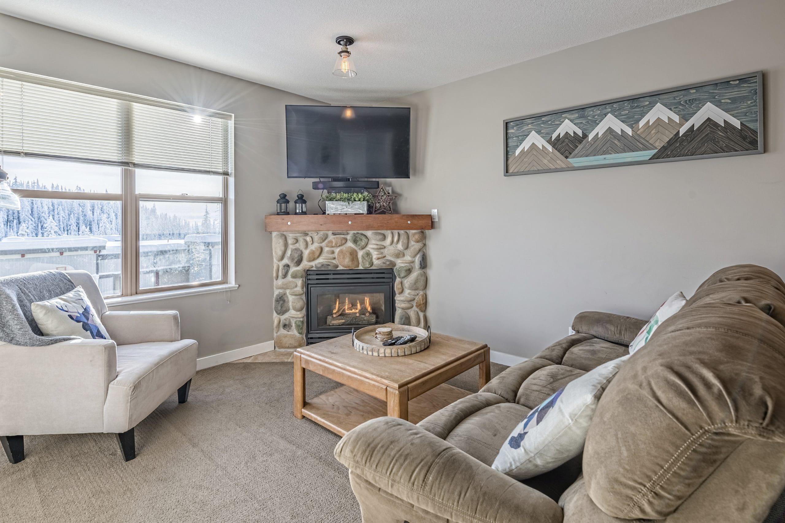 Cozy second floor condo with ground level access. Pet-friendly, bright windows with gas fireplace, TV, BBQ on patio, and air conditioning in unit. It's pet-friendly too!