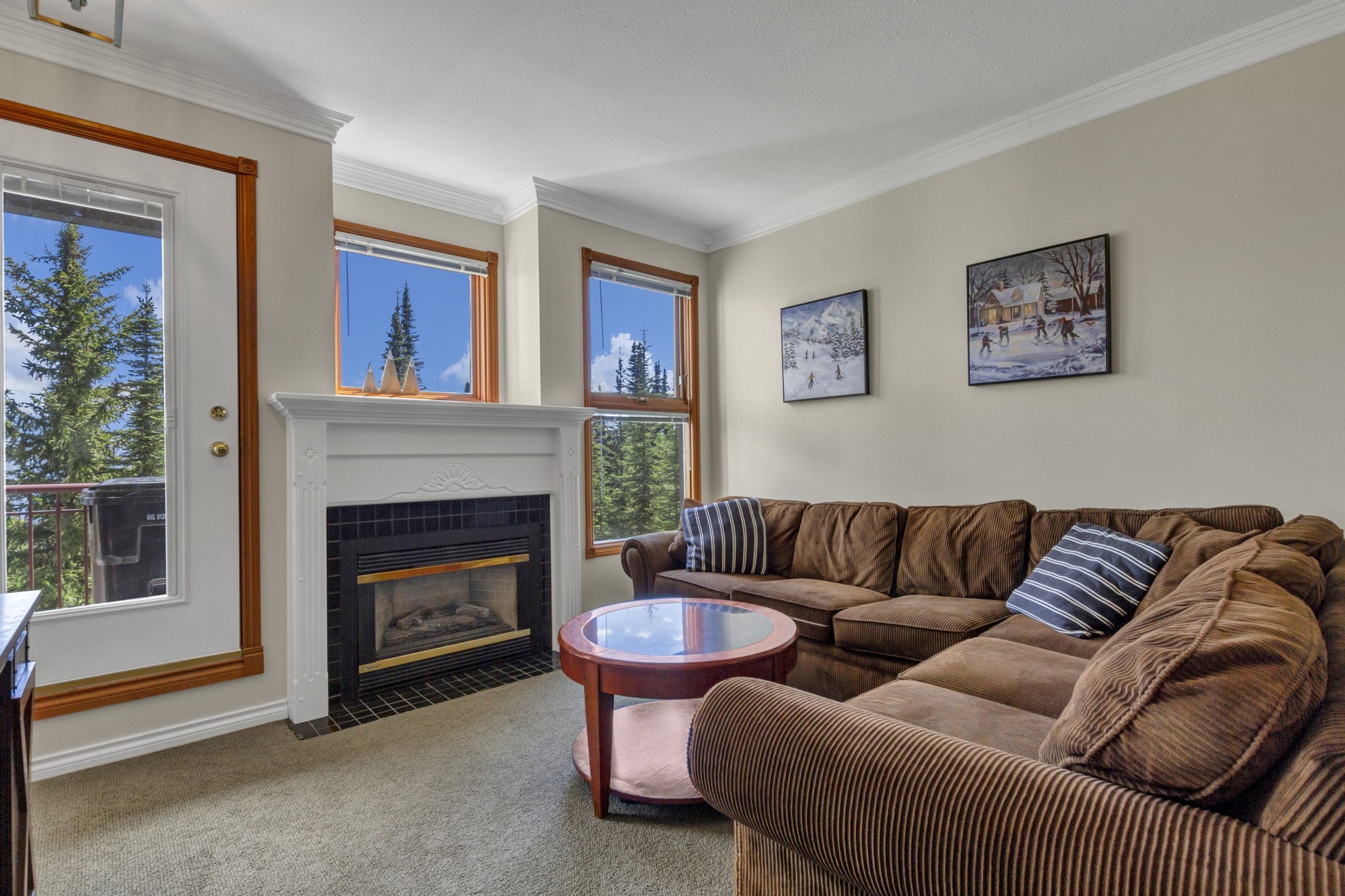 Grandview condo living room with bright open windows and incredible mountain views. Gas fireplace, tv, laundry, outside deck, BBQ and amazing ski-in and out access from the building.