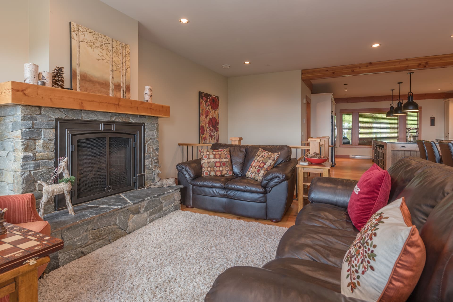 Upper Living room couches with large gas fireplace, large dining area and executive kitchen with all the extras for family and friends. Ski in and out right from the yard into the private hot tub. Private laundry, garage and gear/ski room close to the trails.