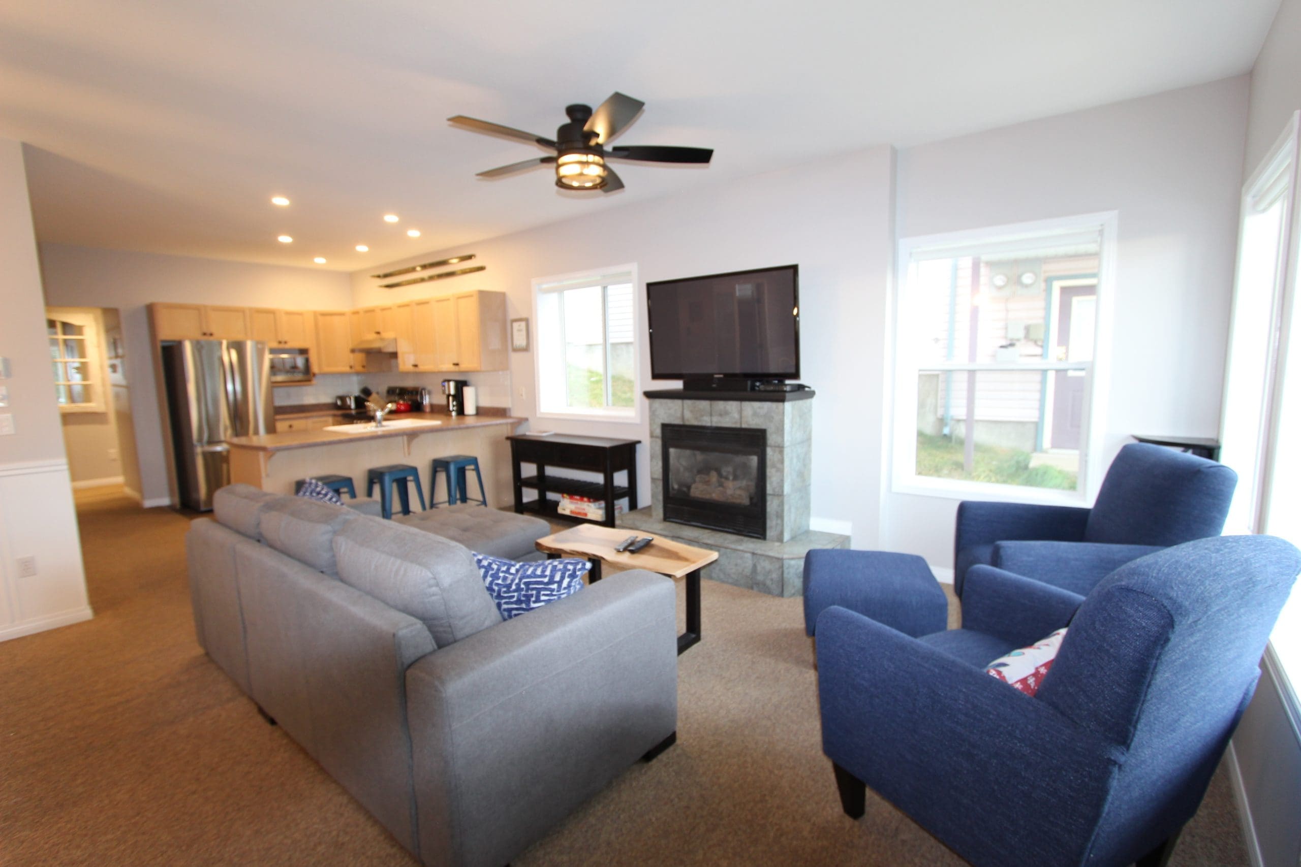 Living room of newly renovated 2 bedroom suite backing onto the Alpine Meadows chairlift. Ski right out from your backyard to start the day, and a quick walk to the village. Gas fireplace, TV, BBQ, private hot tub, private laundry and boot/ski room.