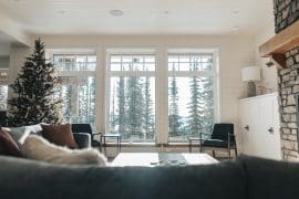 Living room with large bright windows and incredible views. Large gas fireplace, open concept living area and large, well equipped kitchen. Private hot tub, laundry, lower level den/games room, ski room and garage for storage or parking.