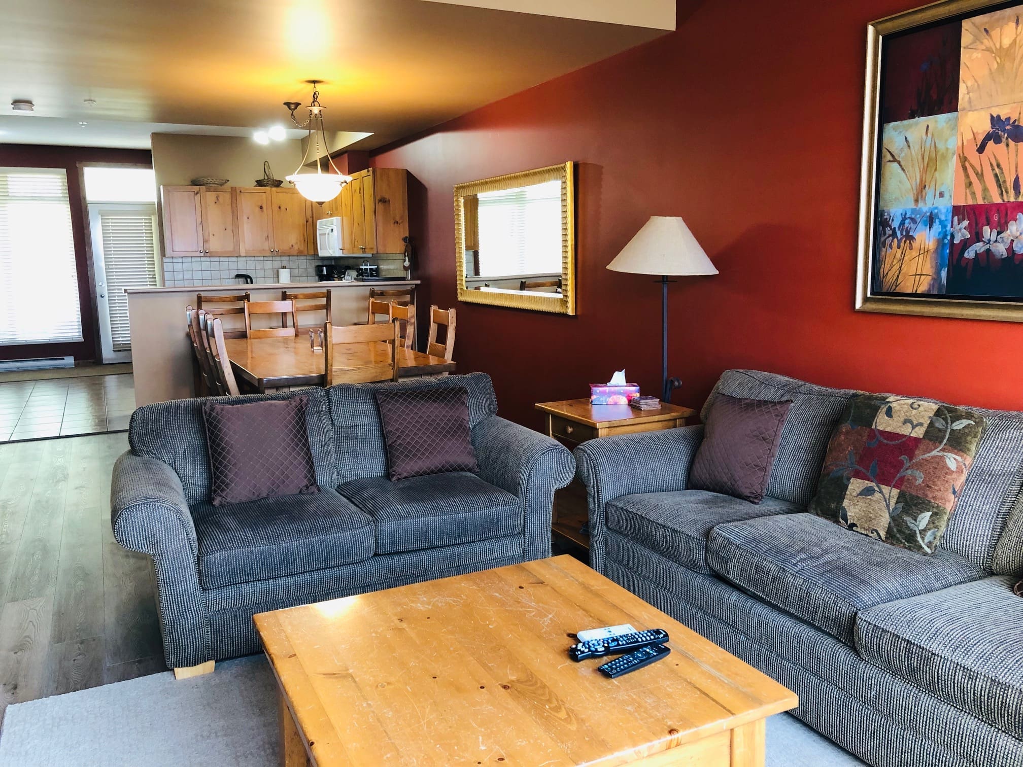 Main floor of 3 level townhouse at Creekside with open living area, dining table, gas fireplace, TV. Private hot tub, laundry, garage, and great ski in and out access from unit.