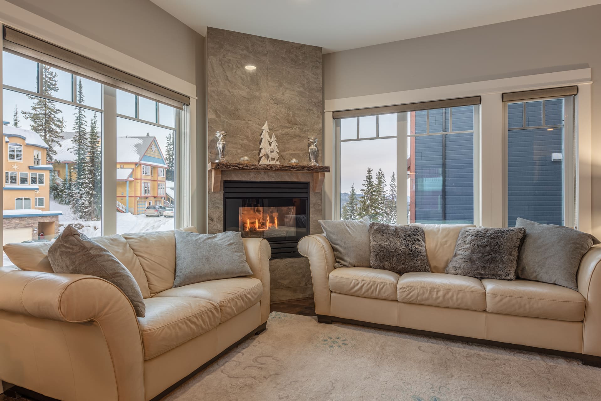 Upper living room of home with bright open windows, fully re-done inside with no expense spared. Gas fireplace, large dining table and area for family and friends to spread out. Private mudroom for storage and gear, private laundry and semi-private hot tub. Pet-friendly too!