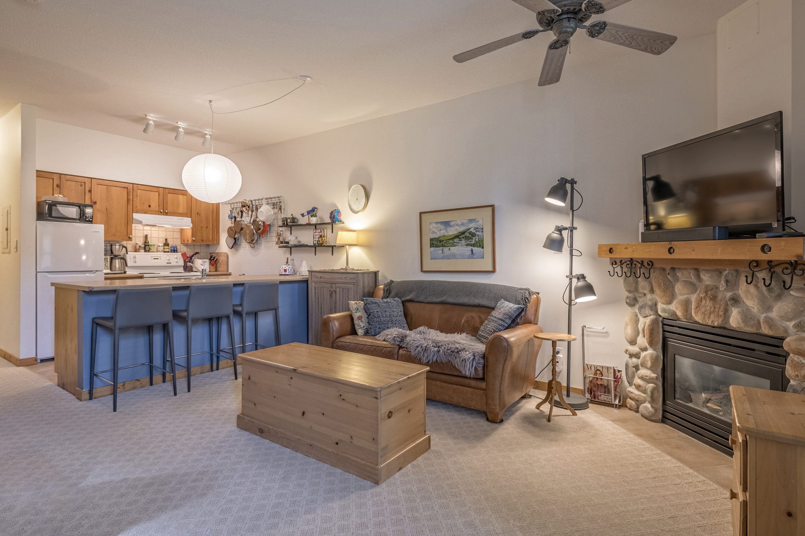 Cozy Studio Condo at Creekside Complex with gas fireplace, tv and murphy bed in living room.