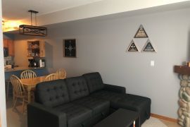 Alpine Oasis pet-friendly ground floor condo at Creekside. Slopeside for easy ski-in and ski out. Cozy living room with gas fireplace, tv, an d dining table.