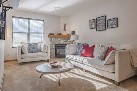 Living Room of Newly Renovated 2 bed/1 bath ground floor condo at Creekside. Ground level access with balcony overlooking chairlifts. Gas fireplace, TV, free parking and fully stocked kitchen.