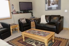 Mountain View Private Suite living room. Fireplace, TV, BBQ on deck, private hot tub and close to the village and tube town. Ski out directly from your door to the Silver Queen Chairlift.