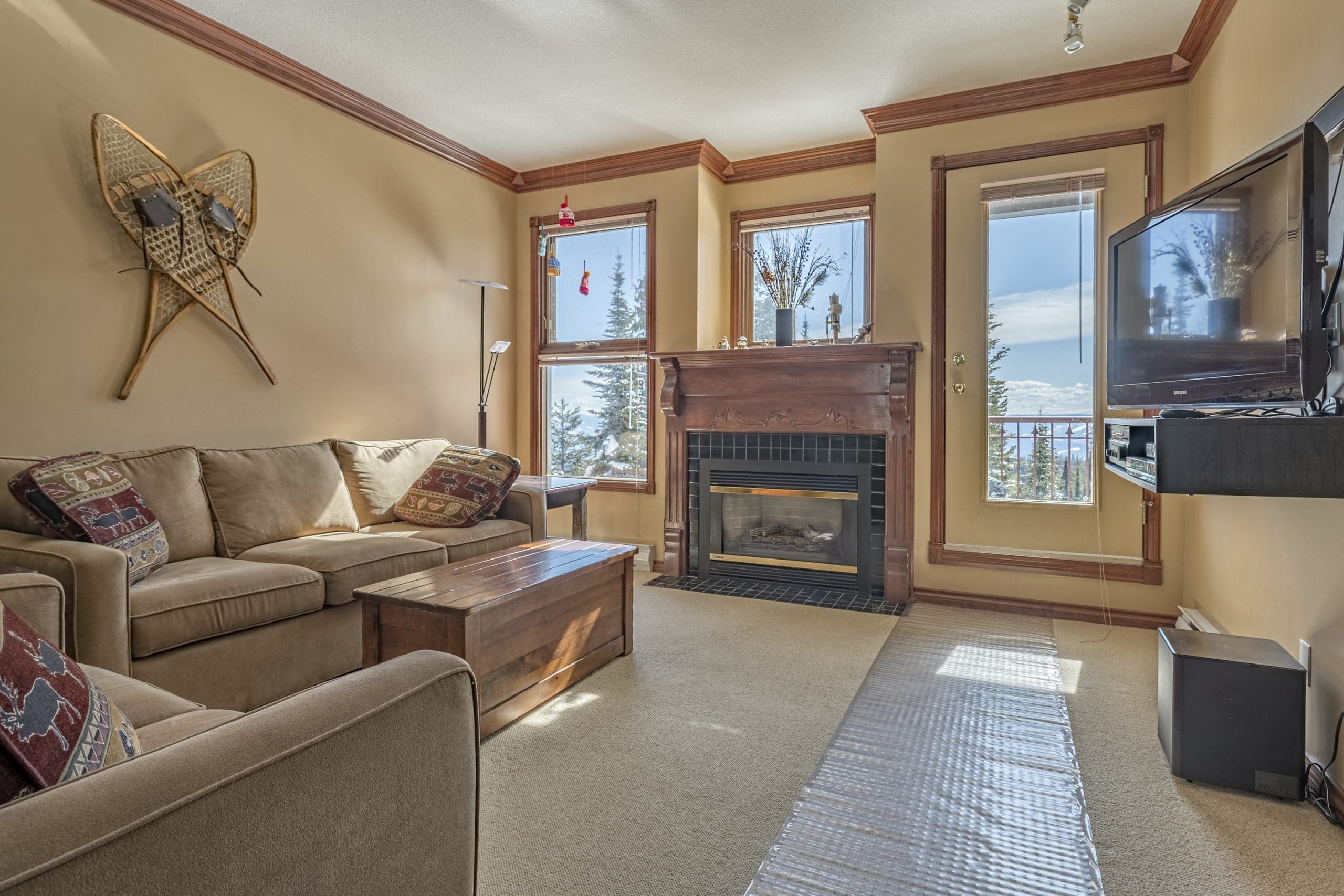 Cozy second floor condo with large bright windows with mountain views, private deck, laundry in unit, and it's pet-friendly!