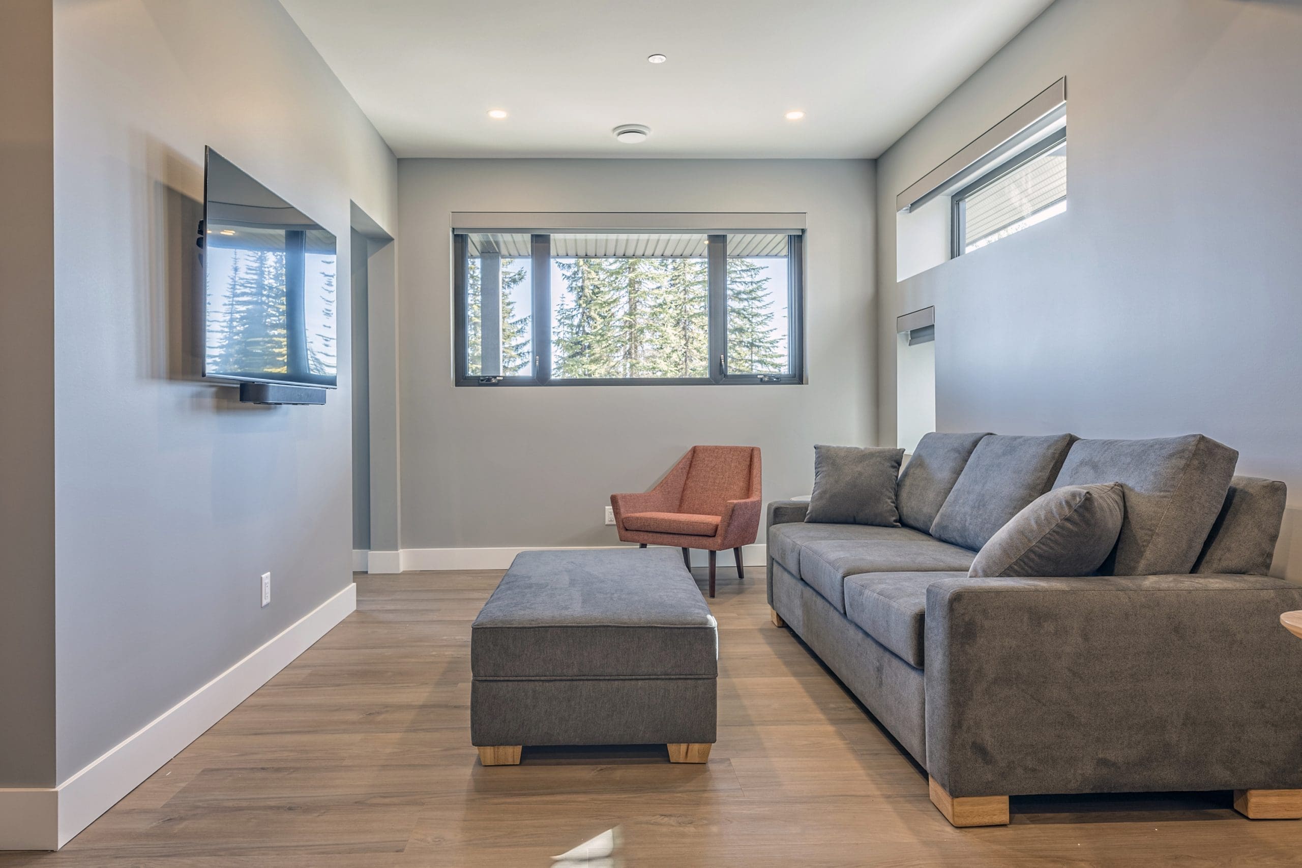 Living room of private 1 bedroom/1 bathroom suite on The Ridge. Private entrance, private hot tub and laundry, large heated ski room. Ski right from the ski room door to access the skiway to the chairlifts.